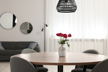 Poster - Chairs and table with vase of red rose flowers in dining room. Stylish interior