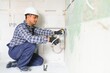 © Serhii - Indian plumber installing water equipment - meter, filter and pressure reducer