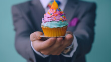 closeup of hands holding birthday cake 