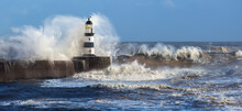 Waves Crashing Over Seaham Lighthouse In The Northeast Of England.