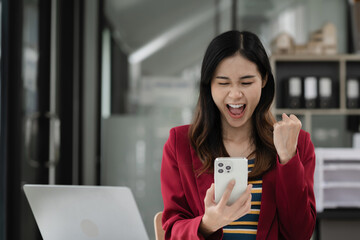 Happy excited smartphone user enjoying, success, achieve, high job result. Euphoric businessman using cellphone, reading text message, feeling joy, making hand winner gesture, laughing