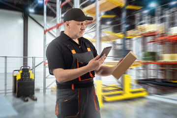 Poster - Man works in warehouse. Storekeeper guy with tablet. Warehouse employee uses app. Storage technologies. Man with gadget in warehouse hangar. Storekeeper with soap at work. Art blurred