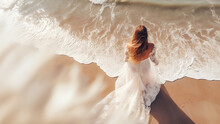 Creative Wedding Photography. Portrait Of Bride In White Wedding Dress Standing On A Beach By The Sea, Taken From Above, Top View.  AI Generative.