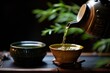 close-up of a japanese teapot pouring green tea into a ceramic cup