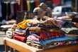 a pile of vintage clothing on a table at a flea market