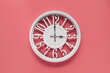 Circle clock on pink background wall