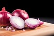 Detailed shot of sliced red onion and whole bulb on rustic wooden table