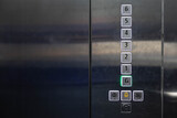 Fototapeta  - braille signage on elevator buttons on the stainless steel wall. elevator button with number and braille letter.