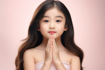 Aufkleber - A young girl wearing a white dress is holding her hands together. This image can be used to depict innocence, prayer, or a peaceful moment.