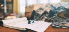 Miniatures And Blue Dice Place On Adventure Story TTRPG Book Role Playing Tabletop Game And Board Games Hobby