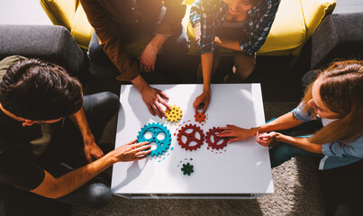 Business team work together and combine pieces of gears. Partnership and integration concept