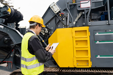 Aufkleber - Engineer with digital tablet next to road construction machine.