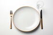 A plate with food on a white table, accompanied by a fork and knife. Generative AI