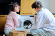 © Valerii Honcharuk - Family mother and teenage son together, at home near washing machine
