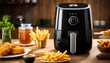 Black oil-free or air fryer appliance on a wooden table in a kitchen with a cement wall.