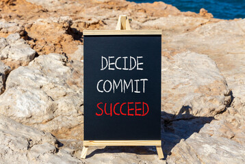 Wall Mural - Decide commit succeed symbol. Concept word Decide Commit Succeed on beautiful black chalk blackboard. Beautiful stone beach sea blue background. Business decide commit succeed concept. Copy space.