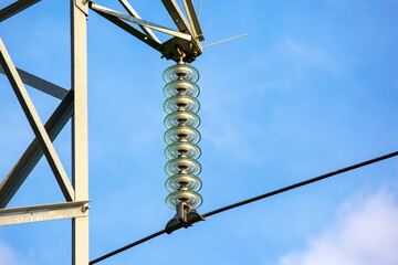 Wall Mural - High voltage tower with electrical voltage wires isolates close-up against the background of clouds. Energy industry.