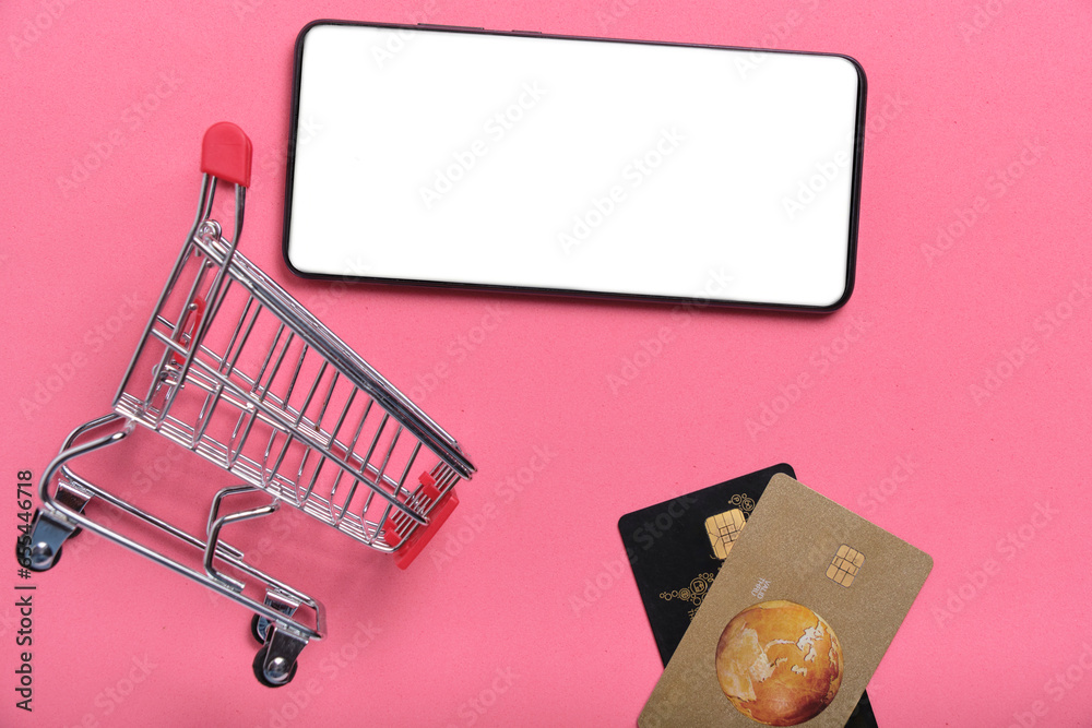 Shopping cart credit cards and cell phone with white screen pink ...