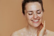 © Alliance - happy modern female with wet face washing