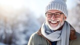 Adult man with glasses and warm clothes lis laughing while standing outside. Winter season. Bokeh Background 