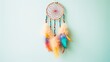 Picture a dreamcatcher with rainbow-colored threads and beads, casting a vibrant aura against a clean white wall.