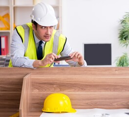 Wall Mural - Young male architect working in the office