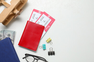 Canvas Print - Flat lay composition with tickets, passport and wooden model of plane on white table, space for text. Business trip