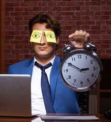 Wall Mural - Young businessman working in the office at night