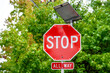 © knelson20 - Stop sign with flashing LED lights powered by a solar panel, all way sign below