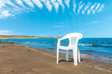 Poster - Lonely chair on a sandy beach. Summer vacation