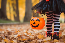 Kid Going Trick Or Treating. Child In Festive Halloween Costume With Cute Jack O Lantern Basket