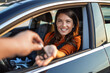 © Graphicroyalty - Optimistic female client sitting in brand new car and taking keys from crop dealer in dealership. woman make purchase in cars showroom. she sits inside of beautiful car and look at sales agent