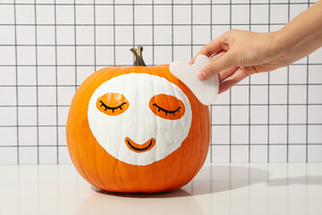 Wall Mural - Pumpkin with face mask. Face care concept