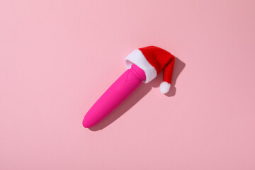 Sex toys with Christmas Santa hat, top view.