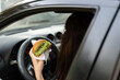 © Andrii Lysenko - Woman driving car while eating delicious hamburger. Standing in traffic jam