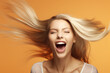 Happy Excited Woman Having an Orgasm Enjoying Having Fun depicting Good Sex Education Daydreaming Feeling High Mint Peppermint Gum Hyper Thrilled Blonde Long Hair Orange Solid Color Background 