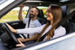 © F8  \ Suport Ukraine - Beautiful young couple sitting on the front passenger seats and smiling while handsome man driving a car