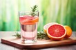 a glass of detox water employing grapefruit and rosemary