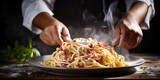 Fototapeta  - Close up of hand handling Italian pasta carbonara.