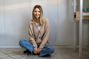 Wall Mural - People leisure lifestyle concept. Young female wearing stylish clothing laughing having rest at home