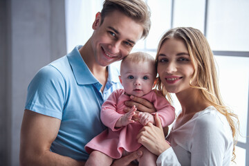 Wall Mural - Young couple with baby