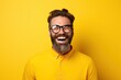 © Dina - Man with beard wearing glasses laughing on yellow background. Optics store ad, lifestyle portrait banner.