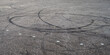 © Jarama - skid marks on a road surface. Circular tire marks left by drivers doing doughnuts