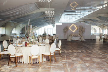 Wall Mural - Luxurious restaurant. Luxurious interior, white tables, serving dishes and glasses for guests