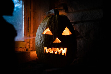 Wall Mural - scary Halloween pumpkin glowing in window at night