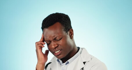 Wall Mural - Stress headache, black man or doctor in studio with fatigue, burnout and frustrated healthcare worker. Anxiety, pain and tired medical professional, exhausted hospital employee on blue background.