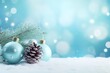 Beautiful gentle composition for Christmas card, congratulations with sprig of fir tree with toys and with drifts of snow on light turquoise background 