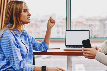 Canvas Print - Colleagues communicating with each other between computer with blank screen area