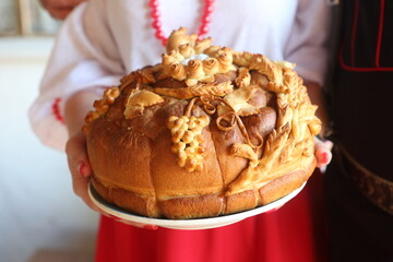 Female hands holding homemade bread on a towel