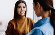 © BullRun - Rear view of female boss explaining information to young caucasian employee gesturing
